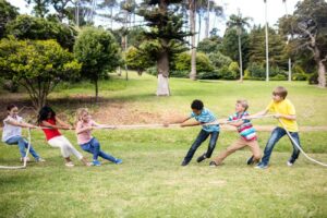 54923911 children pulling a rope in tug of war in the park